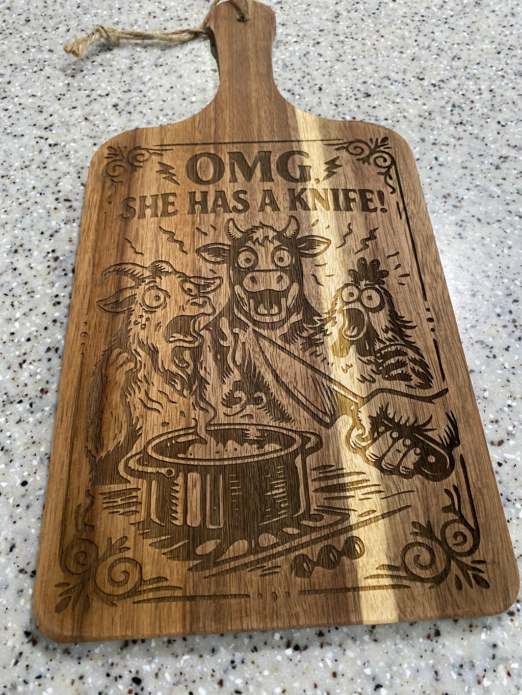 She’s got a knife! ( cutting board)