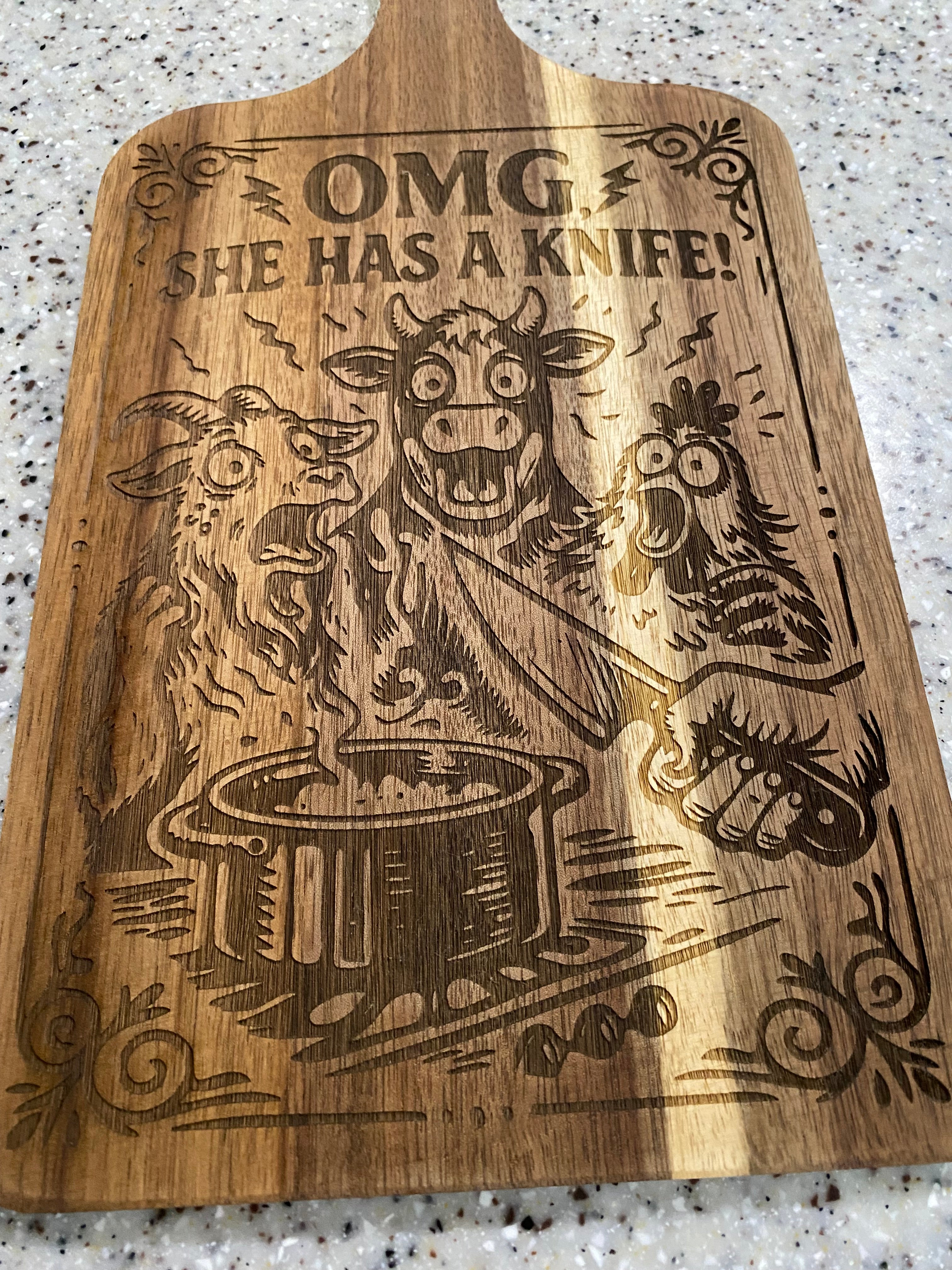 She’s got a knife! ( cutting board)
